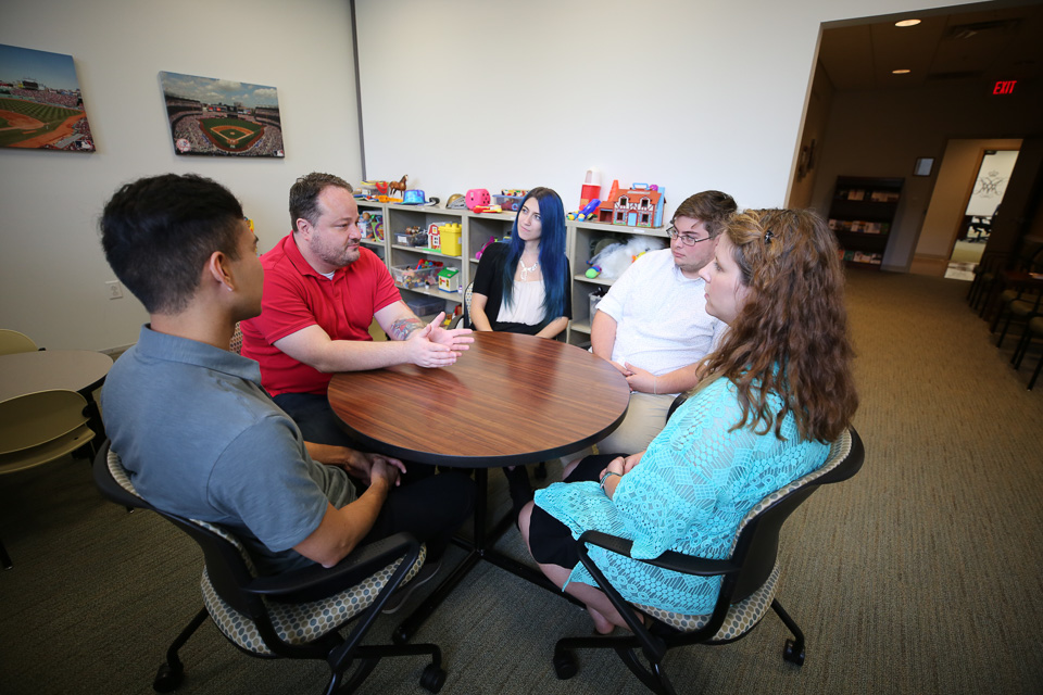 Student interns hold a discussion in one of the New Horizons Family Counseling Center and New Leaf Clinic meeting rooms.